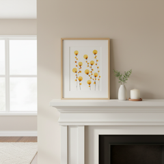 Golden dandelion botanical ink painting framed on a bright white fireplace mantle