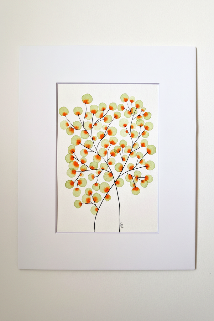 Green and orange tree botanical artwork in white mat on neutral background