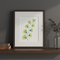 Sage green leaf botanical ink painting framed on a dark moody wooden shelf