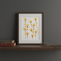 Golden dandelion botanical ink painting framed on a dark moody wooden shelf